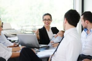 ARbeitende Mutter mit Baby im Büro